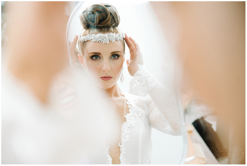 bride adjusts beaded hair piece